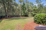 The sunroom provides backyard and wooded views.