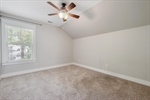 Vaulted ceiling and refreshing lighted fan.