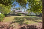 Screen porch provides backyard and wooded views.