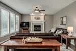 Lighted ceiling fan and cozy fireplace.