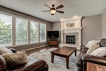 Living room with floor to ceiling wall of windows.