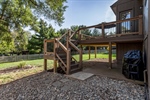 The deck overlooks the large and fenced backyard.