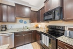 Abundant cabinetry and tile backsplash.