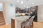 From the kitchen stairs lead to the upper levels.