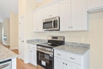 Sleek white cabinetry and granite counters.