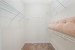 Walk in closet with built in shelving.