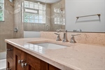 Renovated bathroom featuring travertine tile