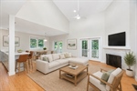 Virtually staged living dining and kitchen.