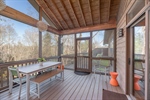 Enjoy the outdoor beauty of the screened in porch