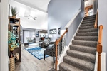 Carpeted stairs to 2nd flr-LR with soaring ceiling