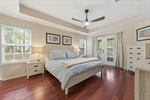 Primary bedroom with smooth tray ceiling.