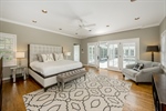 Main level primary bedroom with deck access