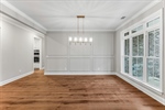 Large windows overlook the front yard.