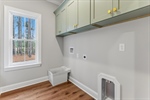 Main level laundry with built in cabinetry.
