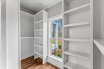 Fabulous walk in closet with built in shelving.