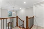Ascend the stairs with iron look spindles.