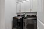 Main level laundry room with built in cabinetry.