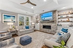 Great room with tray ceiling and built-ins.