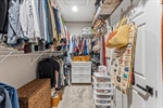 Spacious walk-in closet with shelving.