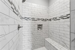 Enormous walk-in shower with bench