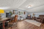 Upstairs bonus room with vaulted ceiling.