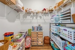 Walk in closet with built in shelving.