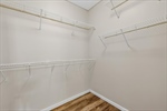 Walk in closet with built in shelving.
