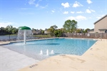 The pool is complete with a water feature.