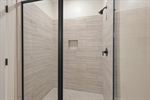 Walk in tiled shower.