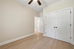 4th bedroom with ceiling fan and double closet.