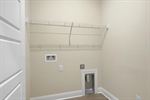 Laundry room with built in shelving.