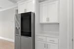 Coffee bar and refrigerator.