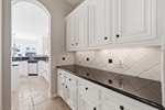 Tile backsplash storage in Butlers pantry