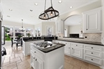 Granite counters travertine floors and backsplash