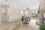 Travertine flooring continues in this space