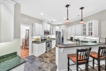 Kitchen with breakfast bar and pendant lighting.