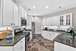 Abundant cabinetry and Ubatuba granite counters.