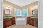 Raised dual vanities with vessel sinks.