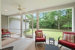 The porch overlooks the private half acre yard.