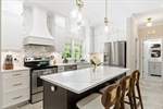 Abundant white shaker cabinetry. Quartz counters.