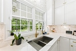 Double undermount sink. Stylish tile backsplash.