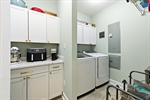 Coffee bar area and mud room with laundry sink.