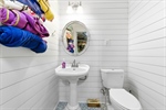 Garage half bath for convenient pool access.