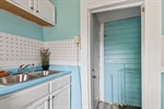 Double sinks and door leading to the backyard.