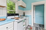 The kitchen offers white appliances.