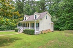 The RV pad is to the right side of the home.