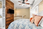 Lovely accent wall and lighted ceiling fan.