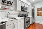 Gorgeous kitchen with full tile backsplash.