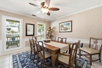 Formal dining room with large windows.