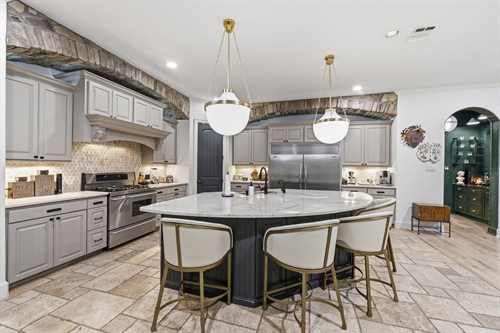 Granite island with seating and farmhouse sink